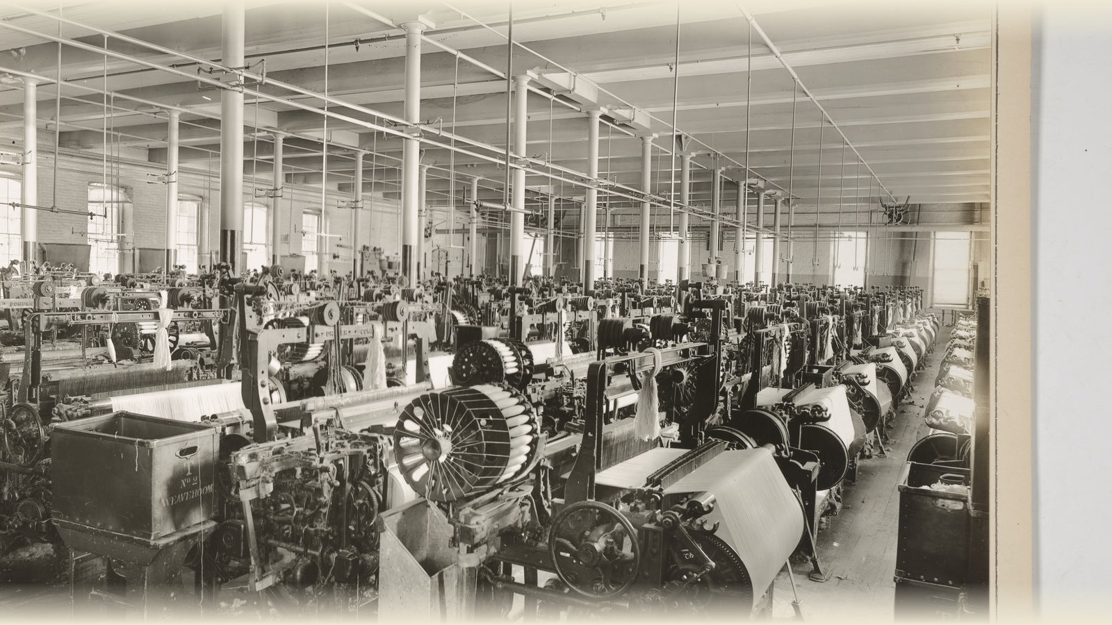 Automatic looms weaving cotton, Weave Room No. 2, John Farnum Co., Philadelphia, 1918. NARA. Public domain.