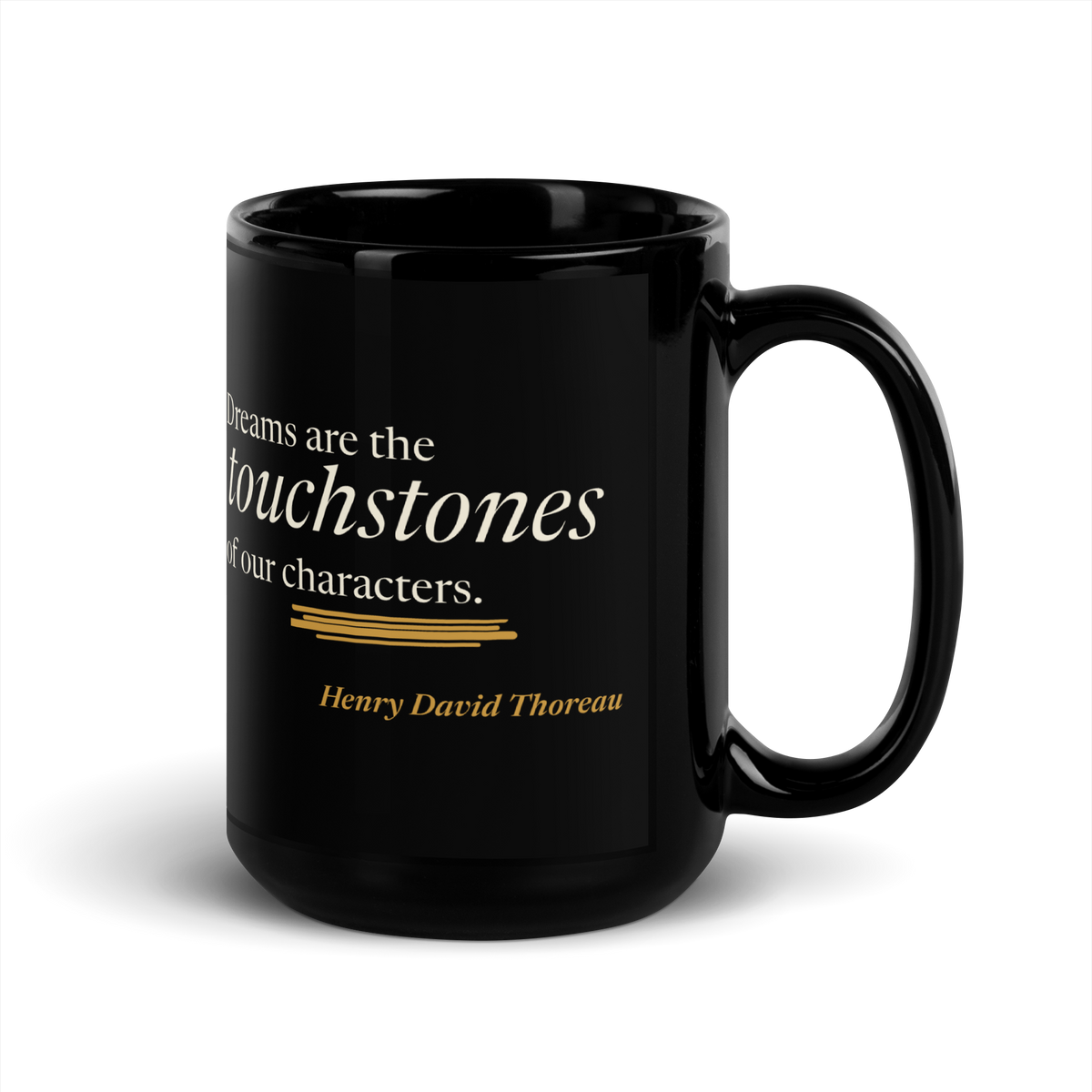 Black 15 oz mug, handle on right: Thoreau's "Dreams are the touchstones of our characters." above a warm matte gold streak.