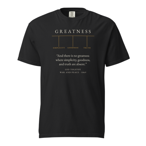 Black t-shirt: GREATNESS in matte amber over SIMPLICITY · GOODNESS · TRUTH, with a Leo Tolstoy quote from War and Peace