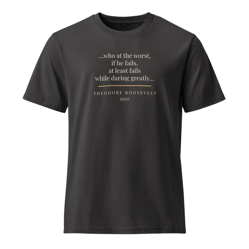 Black organic t-shirt, front: “…at least fails while daring greatly…” Theodore Roosevelt, over a short warm rule.