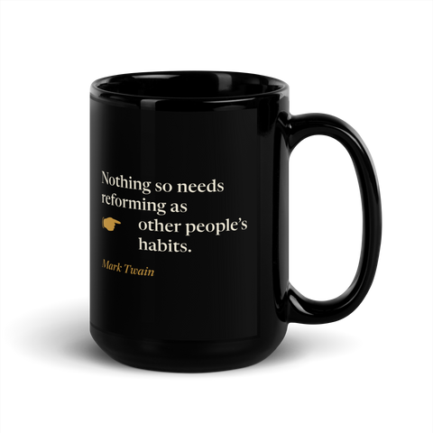 Black mug, handle on the right: "Nothing so needs reforming as other people's habits." Mark Twain, with a pointing hand.