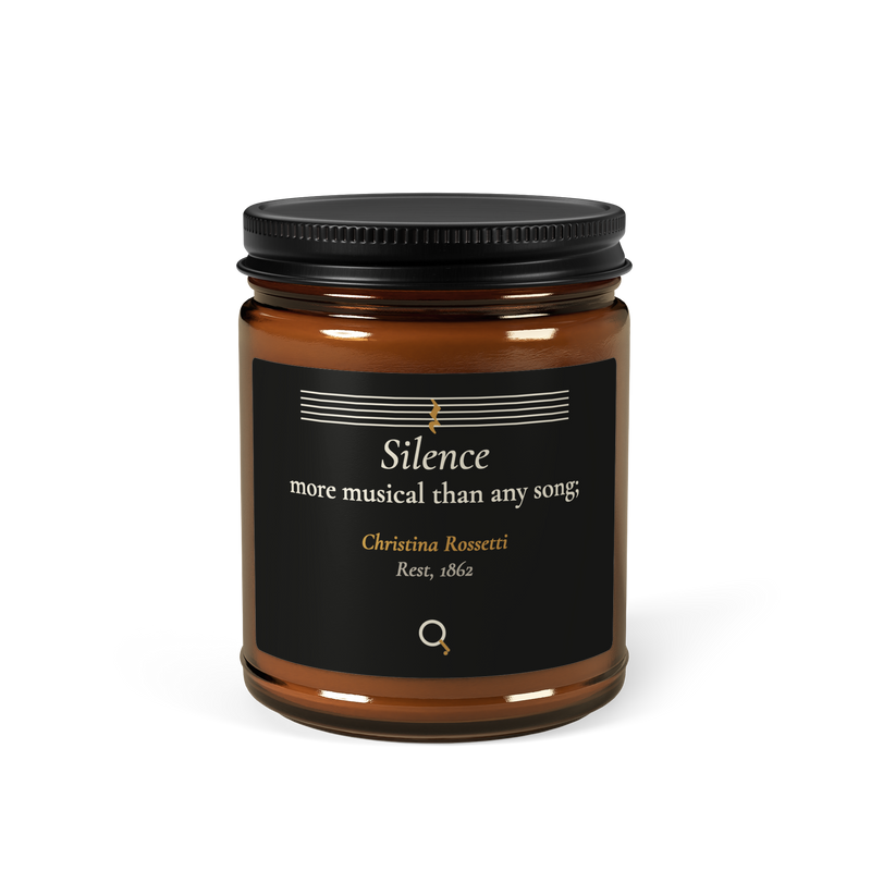 Amber candle jar, front: “Silence more musical than any song;” Christina Rossetti, under a staff with a quarter rest.