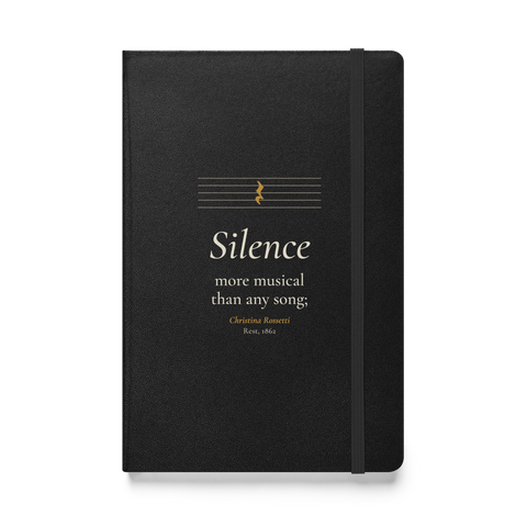 Black hardcover journal, front: "Silence more musical than any song;" Christina Rossetti, under an empty music staff.