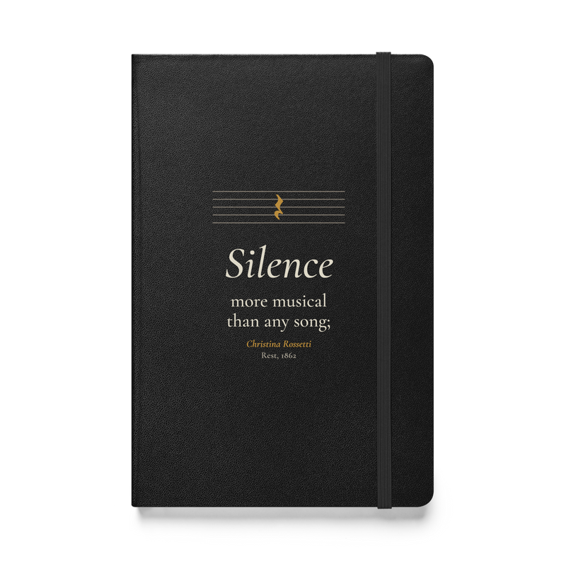 Black hardcover journal, front: "Silence more musical than any song;" Christina Rossetti, under an empty music staff.
