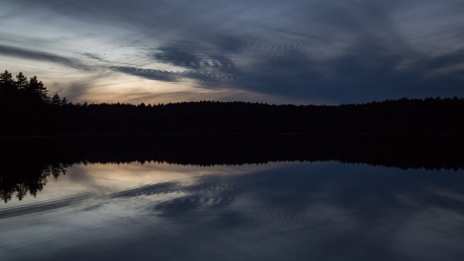 Walden Pond at dusk, December 2012 — still water reflecting a steel-blue winter sky, the actual pond where Thoreau lived from 1845 to 1847
