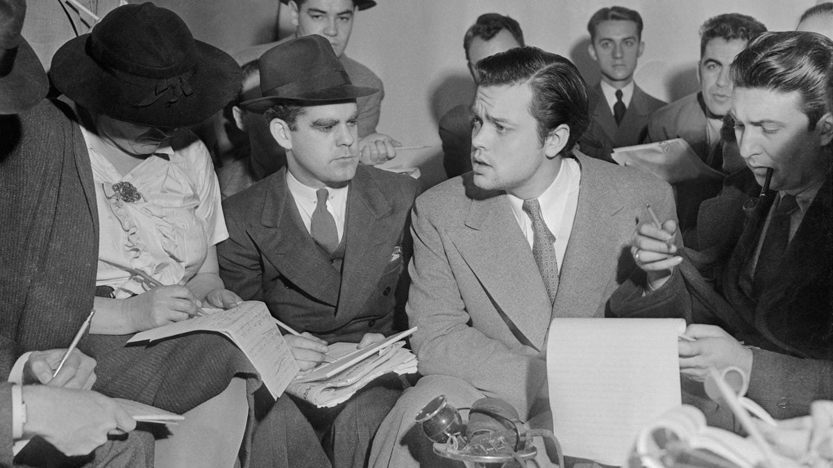 Orson Welles answering reporters the day after his War of the Worlds broadcast, New York, October 31, 1938