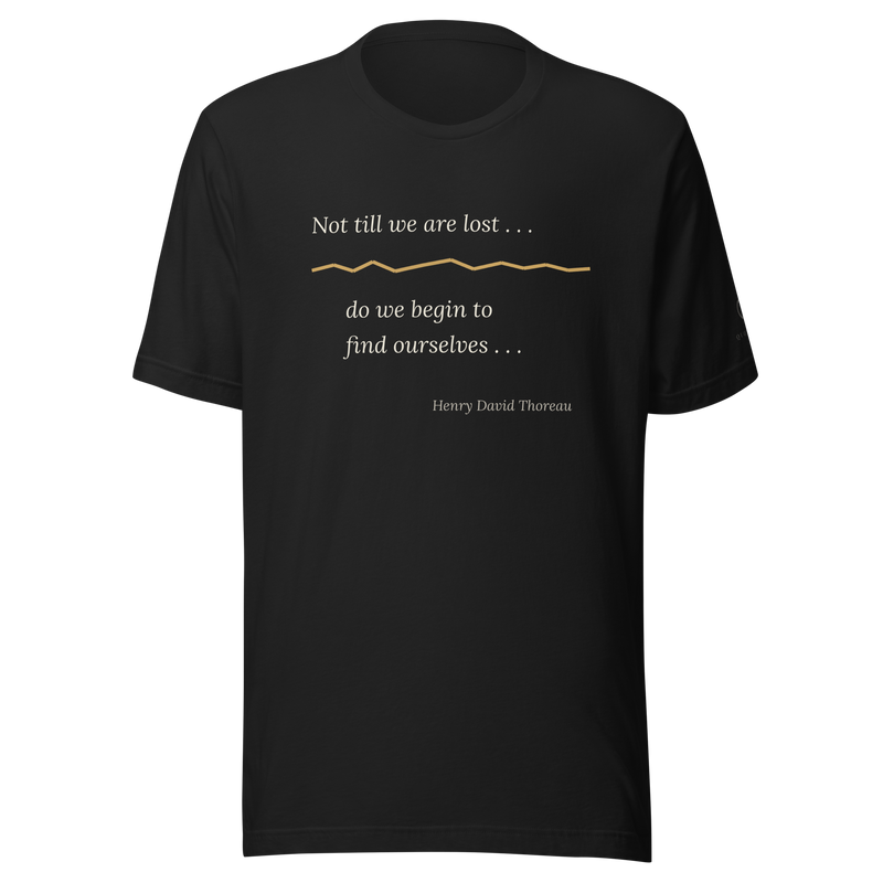 Black t-shirt, front: “Not till we are lost . . .” over a warm matte gold kintsugi seam. Thoreau.