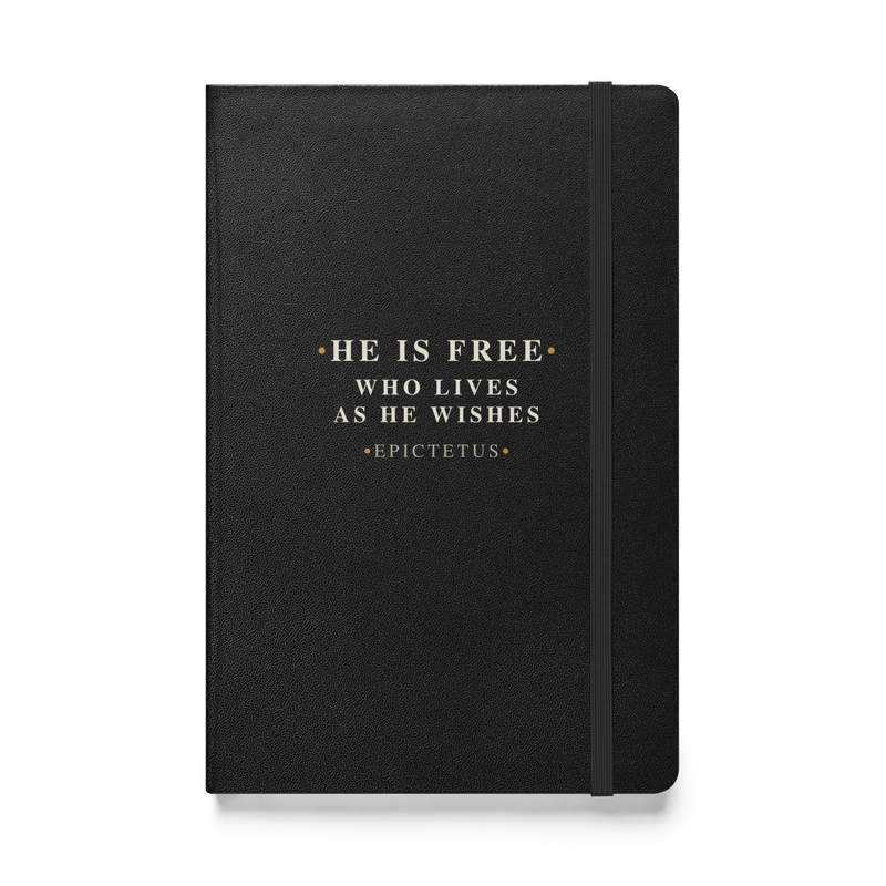 Black hardcover journal, front: “He is free who lives as he wishes.” Epictetus, in Roman capitals.
