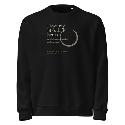 Black sweatshirt, front: “I love my life’s dark hours…” Rainer Maria Rilke, beside a pewter ensō.