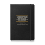 Black hardcover journal, front: “I must study Politicks and War…” John Adams, between two warm rules.