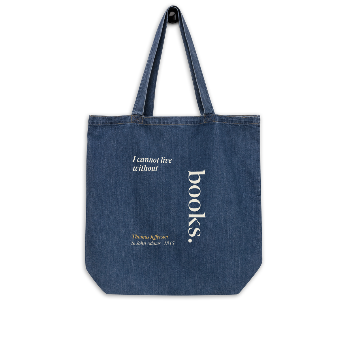 Indigo denim tote bag hanging, front: Thomas Jefferson's "I cannot live without books," with books set vertically.