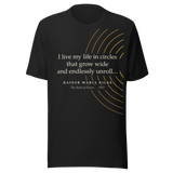 Black t-shirt, front: “I live my life in circles that grow wide and endlessly unroll…” Rainer Maria Rilke.