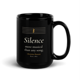 Black mug, handle on the right: "Silence more musical than any song;" Christina Rossetti, under an empty music staff.