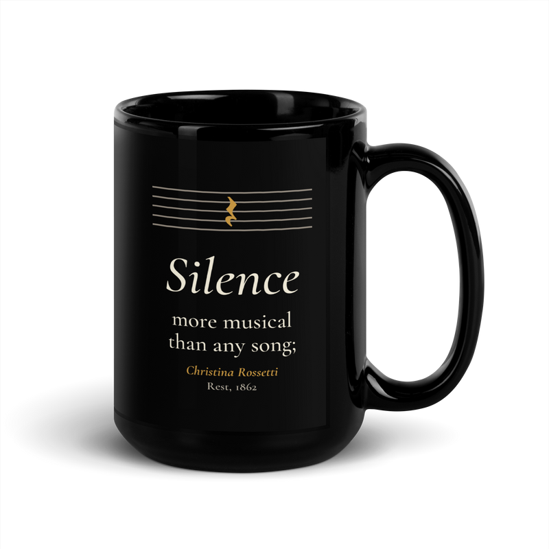 Black mug, handle on the right: "Silence more musical than any song;" Christina Rossetti, under an empty music staff.