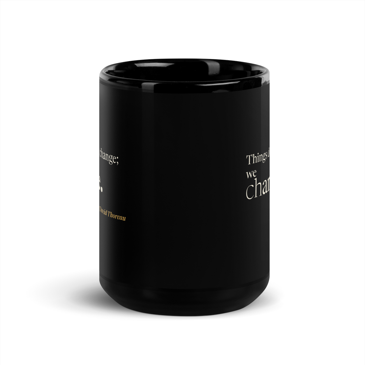 Black mug, front view between the two prints, with the edges of the Thoreau quote on each side.