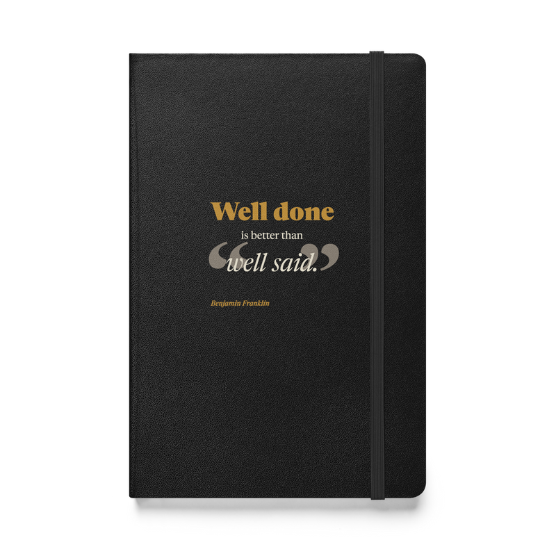 Black hardcover journal, front: "Well done is better than well said." Benjamin Franklin, beside the elastic closure.